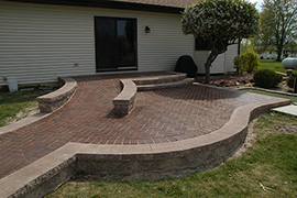 Paver ramp from house to driveway with patio area