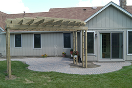 Patio composed of block circles under a pergola.