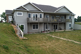 Handicapped capable sloped sidewalk and accompanying landscaping.