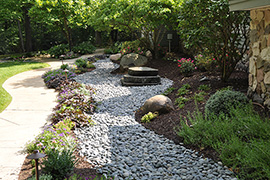 Simple fountain comprised of three slabs of rock.