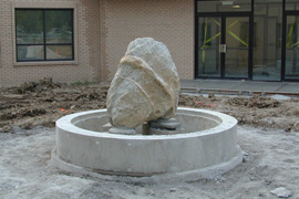 Church courtyard with benches and fountain.
