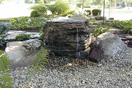 Water trickling out at top of large rock.